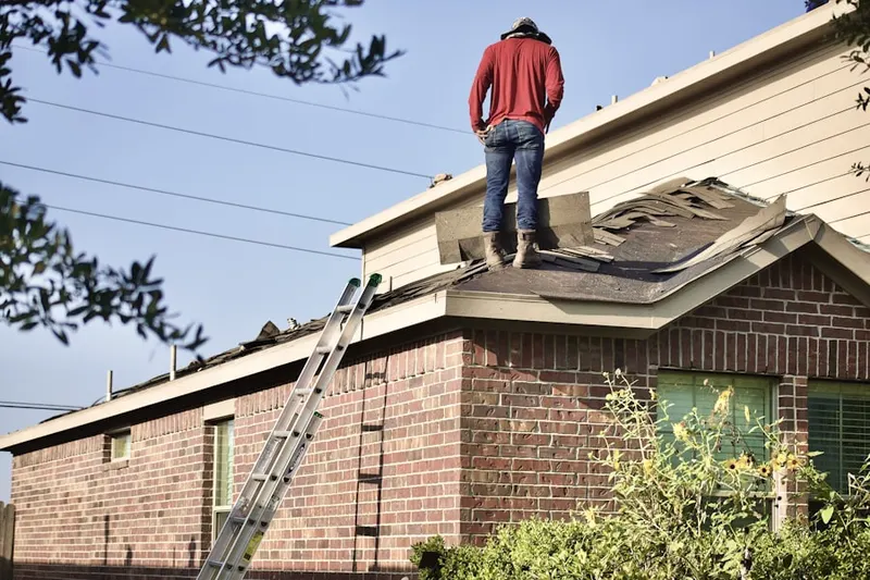 Professional roofer working on a residential roof in Northridge